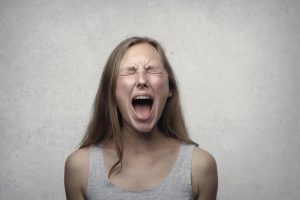 teen girl yelling. Music therapy can address adolescent mental health by developing self-regulation skills.