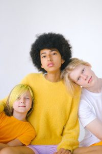 Teens of different ethnicities posing for a picture together and thinking about adolescent mental health
